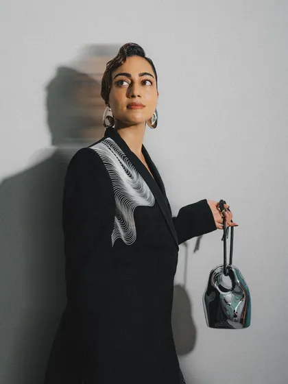 The full view of this slick, sculpted wave hairstyle. It’s a testament to how hair can be a piece of art, perfectly matching the avant-garde feel of the outfit.