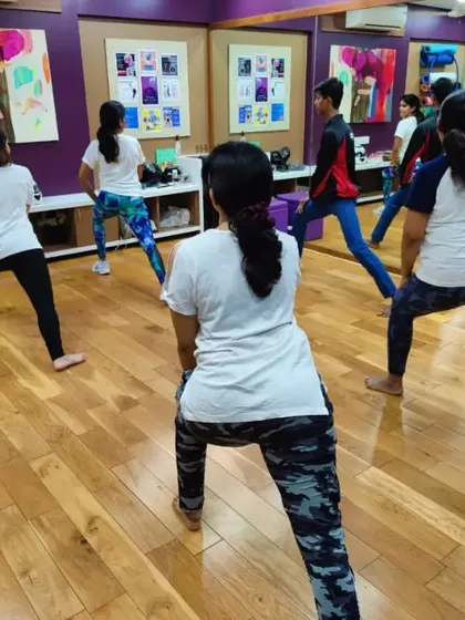 Participants practice basic stances and movements during a corporate workshop. These foundational skills are crucial for maintaining balance and generating power for blocks and strikes.