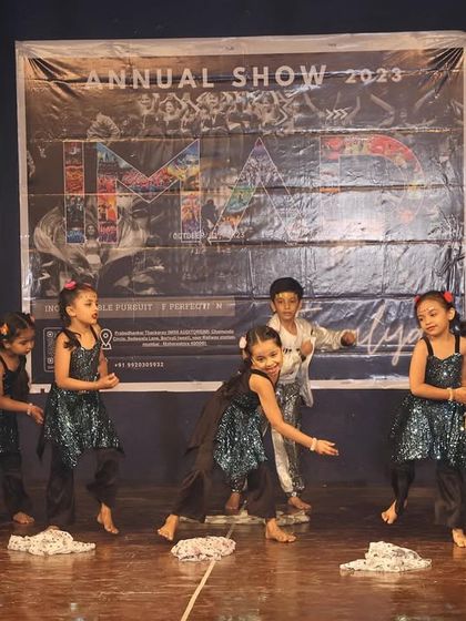 A playful moment from our little ones' performance, using props to tell a story.