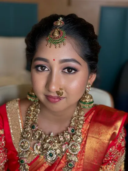 A portrait of my beautiful bride Sowmiya for her Muhurtham in Erode. Her mother-in-law booked me as a surprise, and with no trial, she trusted me completely to create this gorgeous look with defined eyes and a classic red saree.