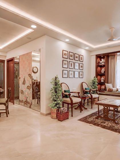 This living room showcases how a subtle, patterned wallpaper can define a space. The partition wall features a custom design with earthy tones, complementing the traditional wooden furniture and creating a warm, inviting atmosphere.