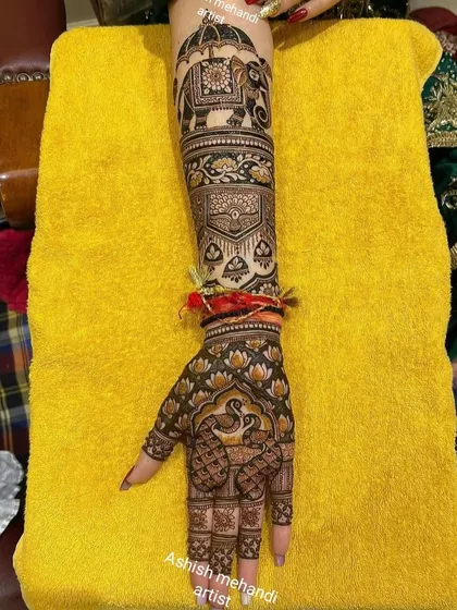 A full view of the previous design, showing how the patterns flow from the arm to the hand. The combination of lotus, peacock, and elephant motifs is a classic choice.