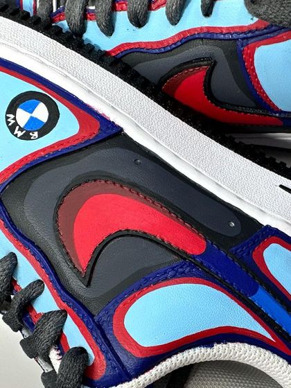 Another detail shot of the BMW custom, focusing on the red, blue, and black color blocking.
