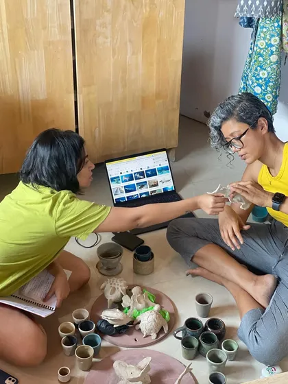 A behind the scenes moment of mentorship. Here, I'm working closely with my professional students, helping them conceptualize and plan their final graduation collections.