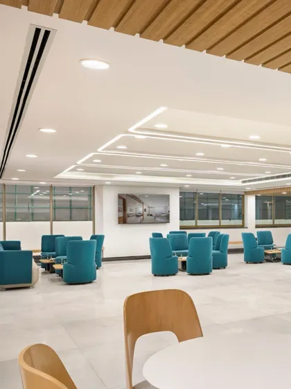 This waiting lounge at Fortis Ludhiana uses calming blue upholstery and flexible seating arrangements. The space is designed to offer both communal and more private areas for waiting, catering to different user needs.