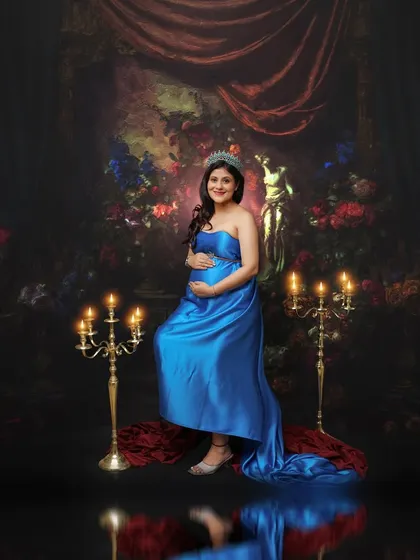 Every mom is a queen, and the crown is the perfect accessory. This portrait in a royal blue gown, complete with a tiara and candelabras, creates a scene of regal elegance.