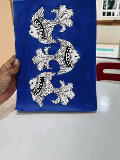 This is a Madhubani painting, an ancient art form from Bihar known for its geometric patterns and vibrant colours. Here, we have the classic fish motif, which symbolizes good luck.