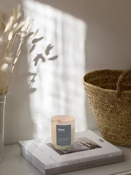 The beautiful glow of our holographic jar candle in a sunlit room. The natural light makes the iridescent jar shimmer.