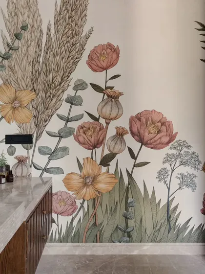 We believe even the smallest details can tell a big story. This bathroom comes alive with a custom hand-painted floral wallpaper, turning a functional space into a work of art. It’s an example of how we layer texture, pattern, and color to create unique, personal moments throughout a home.