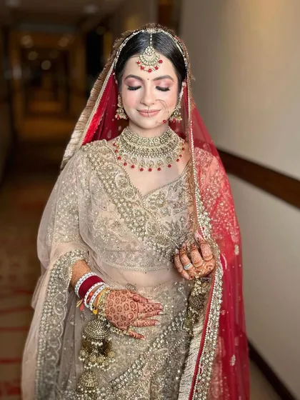 A happy bride, twirling in her beautiful lehenga. The jewellery adds the perfect finishing touch to her wedding day ensemble.