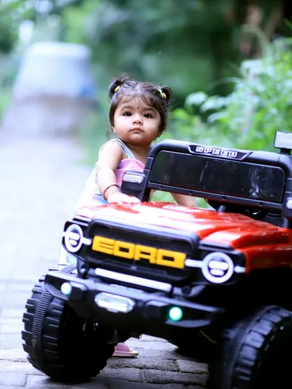 An outdoor shoot with Vaanya for her first birthday. I love incorporating props that kids enjoy, like this red toy jeep. It helps them feel comfortable and allows me to capture their personality as they explore and play in a natural setting.