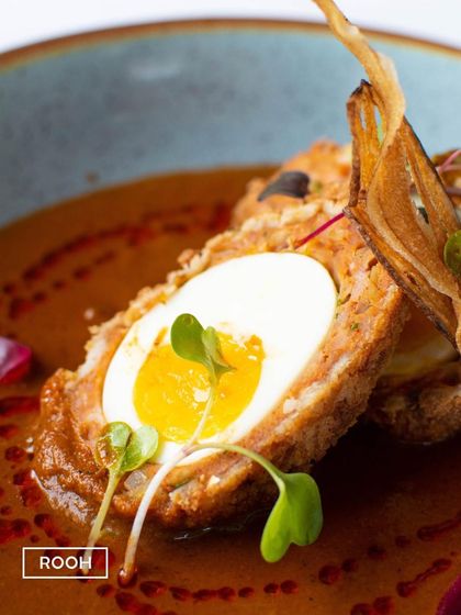 A close-up of the Nargisi Kofta, where you can see the soft yolk of the egg. This dish is a classic from Awadhi cuisine, which I present with a modern, refined touch.