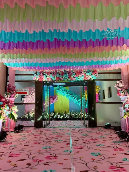 The entrance to the main hall, framed by a pastel floral garland, offering a peek at the decor inside.