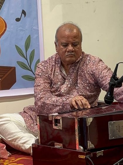 Our guru provides soulful harmonium accompaniment during the Utsav. The presence and guidance of experienced teachers on stage is a core part of our students' learning experience.