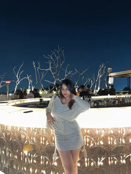 A shot of the knit dress at the bar. This sets the scene and shows the outfit in a typical night-out environment.
