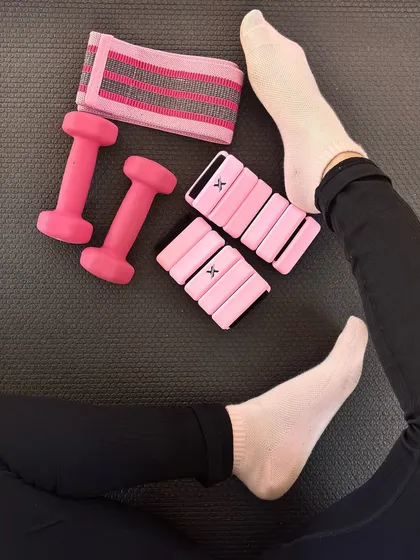 Just the essentials for strength, slay, and sore abs. Pink dumbbells, ankle weights, and resistance bands are a must.