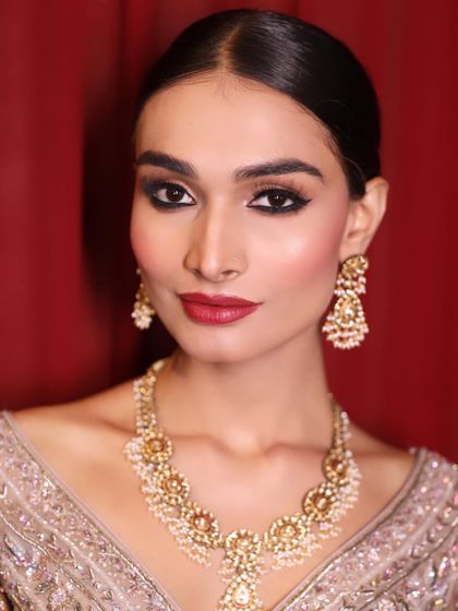 A classic smokey eye and red lip created by our students for a runway model. They learn to work quickly and efficiently in a fast-paced backstage environment.