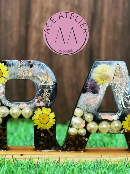 This monogram stand features the initials 'R' and 'A' and was created by preserving a client's special flowers. It's a beautiful way to celebrate a relationship.