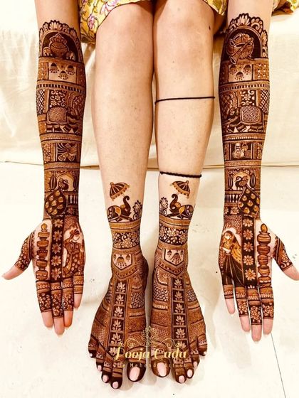 A full bridal mehendi set with traditional figures on the hands and royal peacocks under umbrellas on the feet.