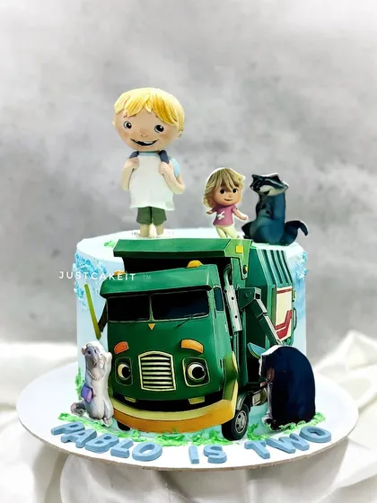 Based on the Netflix kids' show 'Trash Truck', this cake features all the main characters as edible figures. It was a fun and unique theme for a two-year-old's birthday.