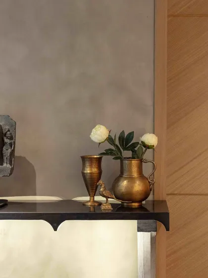 A quiet corner in the Bammi Residence basement lobby, featuring an antique wooden horse from Kutch. This space welcomes guests with a blend of rustic charm and historical significance.