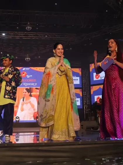 The full team on stage with Jaya Kishori. I am adept at managing multiple personalities on stage, ensuring everyone gets their moment to shine.