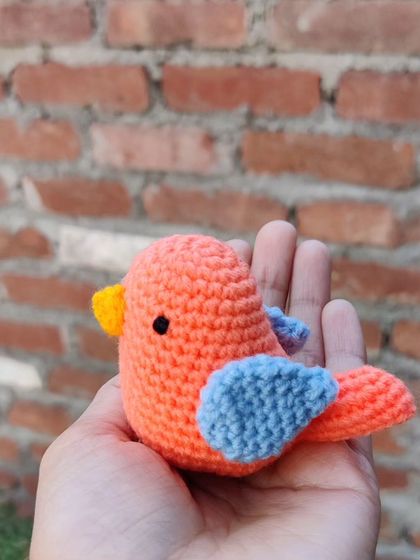 A sweet little crochet sparrow held in the palm of my hand. This small amigurumi bird is perfect as a tiny desk companion or a decorative accent.