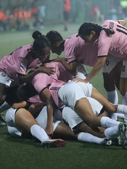 The team piles on top of each other in a massive celebration after scoring a crucial goal. This is pure passion.