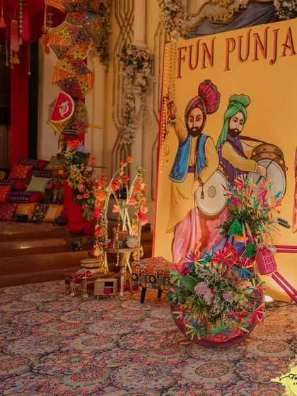 Let's bring the energy of Punjab to your celebration! This 'Fun Punjabi' night setup features quirky, colourful decor elements like hand-painted signage and vibrant floral arrangements, creating an atmosphere that is pure joy and celebration. 💃