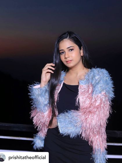 A soft and stylish look I created for singer Prishita. This fuzzy pink and blue jacket paired with a simple black top is both trendy and comfortable, perfect for a young artist.