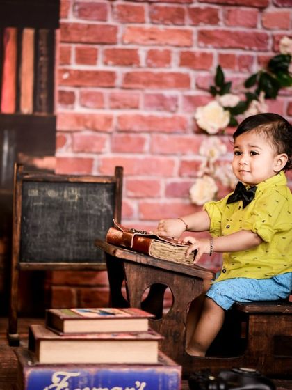 A gallery of our popular school and library theme. These images show the versatility of the brick wall backdrop, mini school desk, globe, and book props for creating a variety of scholarly and classic portraits.