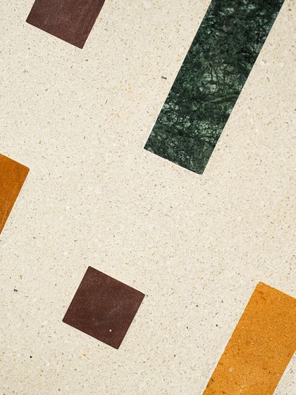 A macro shot of the different natural stones used in our geometric Venetian terrazzo, highlighting their unique colors and textures.