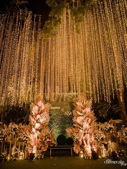 As evening falls, we transform the space with magical lighting. This bohemian-inspired photo booth uses pampas grass and a curtain of fairy lights to create a warm, inviting, and incredibly photogenic corner.