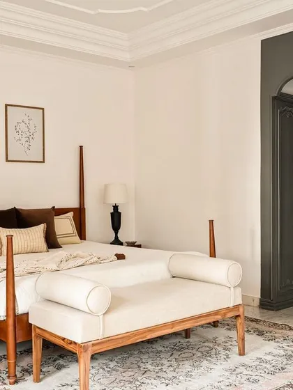 In this master bedroom from the Ivy Lane Villa, I used classic dark wood wardrobes that recede into an arched alcove, creating a sense of depth. The four-poster bed and muted tones contribute to a calm, colonial-inspired elegance.