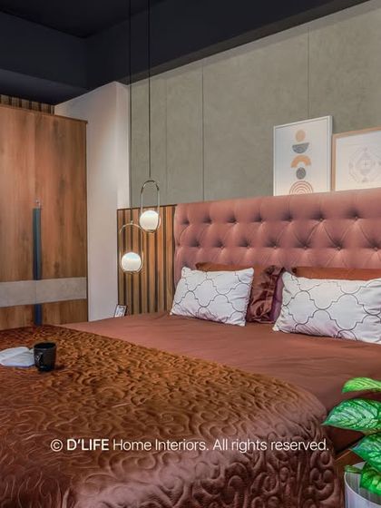 This bedroom features a tufted pink headboard against a wood-paneled wall. The design is modern yet soft, creating a comfortable and stylish personal space.