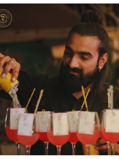 The art of the pour. Here, I am carefully crafting a batch of our signature pink cocktails, ensuring each one is perfectly mixed and ready to be served.
