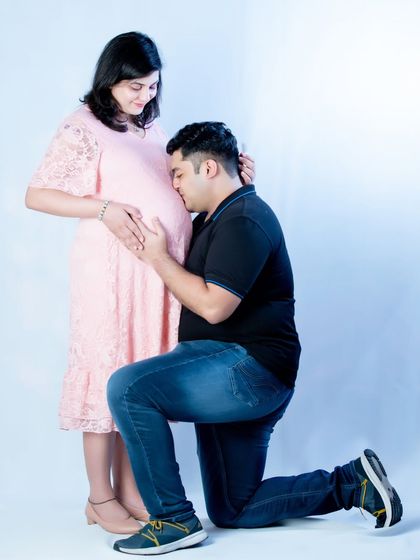 A classic pose that never fails to show love and connection. The partner-to-be listens closely to the baby bump, creating a sweet and heartwarming image.