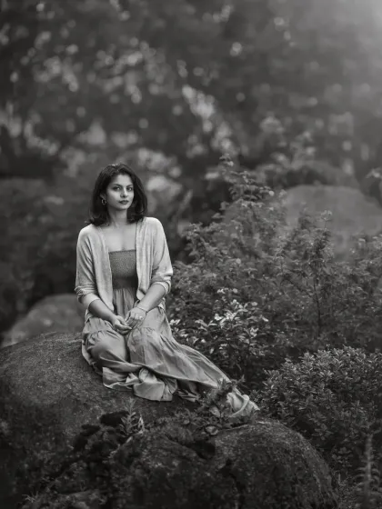 A quiet moment captured on a holiday. This black and white portrait uses the natural landscape to create a serene and contemplative mood. It shows how even a simple, unplanned moment can be turned into a beautiful, artistic photograph.