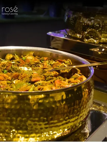 Another delicious-looking Indian main course, served in our signature golden cookware. We curate memorable experiences for opulent weddings and corporate galas alike.