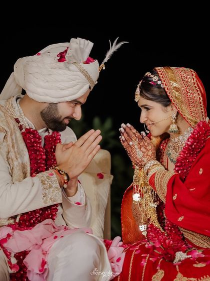 A sweet moment of the couple greeting each other with a 'namaste' during their wedding ceremony.