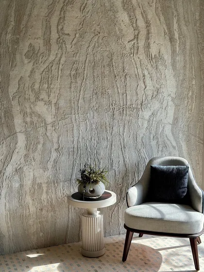 Where light meets design. This structured armchair, paired with a geometric side table and lush foliage, creates the perfect cozy corner where aesthetics and comfort blend effortlessly.