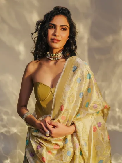 Styling a Benarasi dupatta with a modern bustier top. This is a great way to incorporate traditional textiles into a contemporary, fashion-forward look.