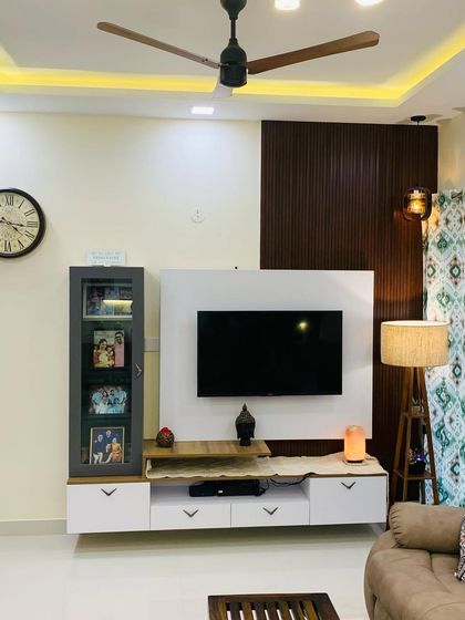 This TV unit is part of a 3-bedroom apartment we designed to have a minimalist yet exceptional look. We used a combination of white laminate and dark wood rafters to create a clean and modern entertainment space.