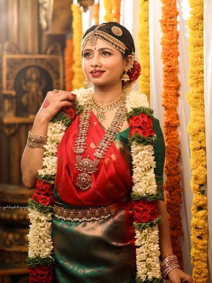 A full-length portrait showcasing the bride adorned with a beautiful garland, ready for her ceremony.