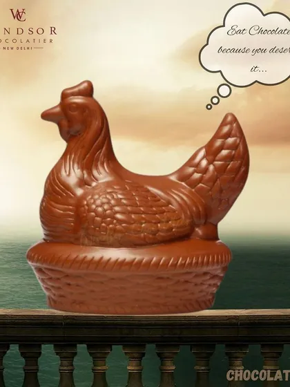 Eat chocolate because you deserve it. This large, hollow chocolate hen is beautifully molded with detailed feathers, sitting contentedly in her chocolate basket.