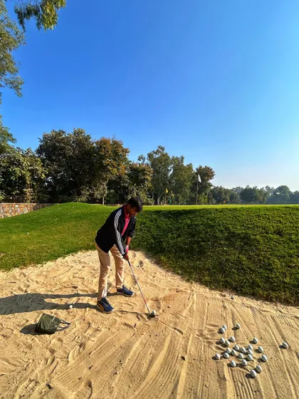 A young golfer practices his sand shots in our dedicated bunker area.