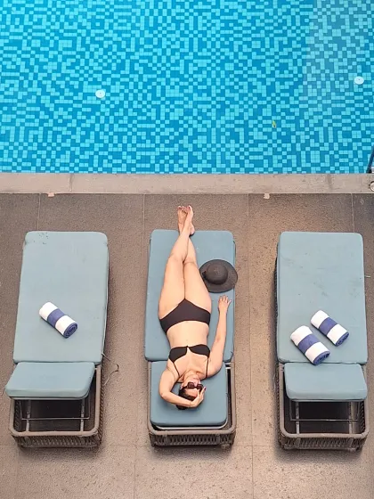 An aerial drone-style shot while lounging by the pool in Goa. This creative angle offers a unique perspective and highlights the beautiful poolside setup.