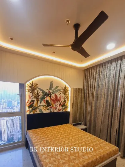 This bedroom features a beautiful wallpaper with a tropical leaf pattern, creating a feature wall behind the bed. The arch-shaped design and cove lighting add to the room's charm.