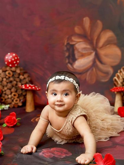 A curious crawler in an enchanted forest. This setup with magical mushrooms and a rich, painted backdrop is perfect for a fairytale-themed sitter session.
