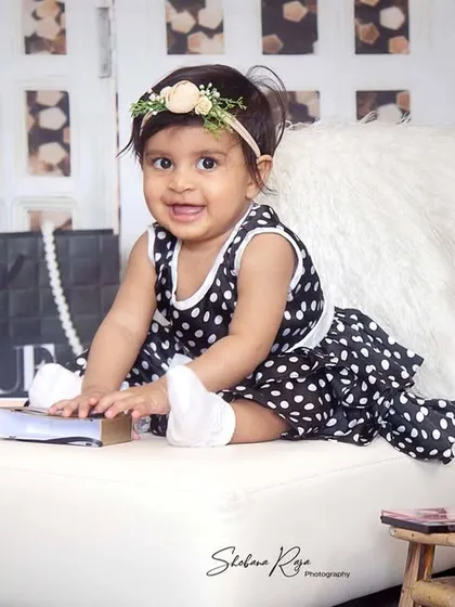 A little bit of glitter and a whole lot of charm. This 7-month-old is a true fashionista in her Vogue-inspired photoshoot, complete with designer bags and pearls.
